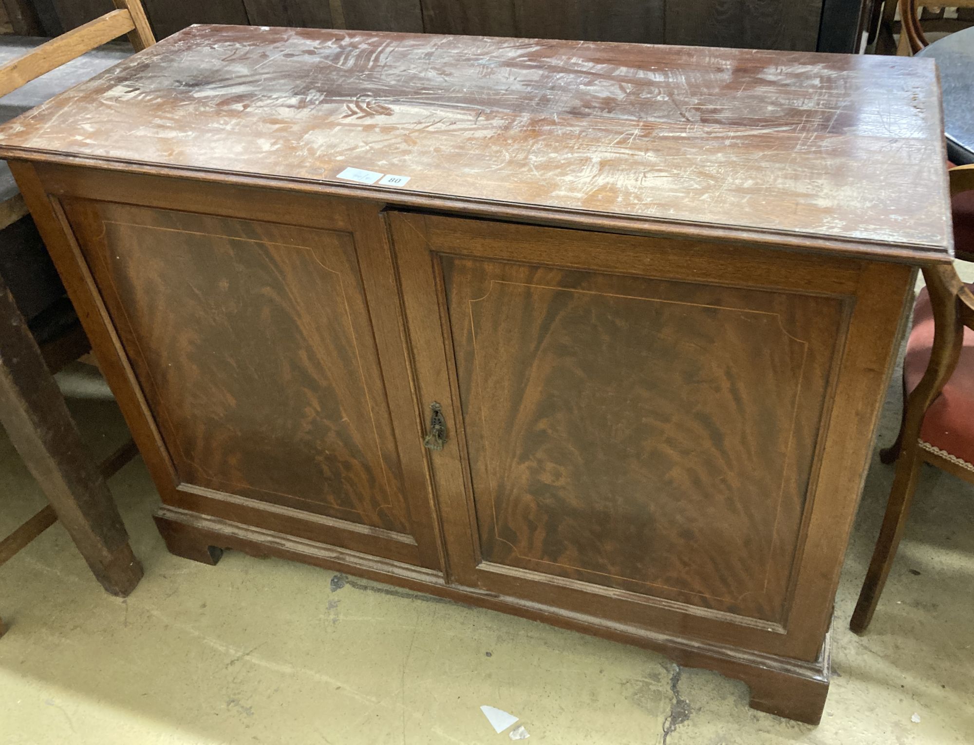 An Edwardian mahogany two door cabinet, length 122cm, depth 51cm, height 86cm